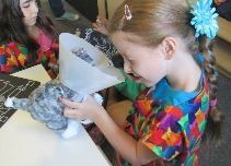 Girl looking at stuffed cat