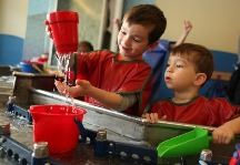 Boys looking at water dripping
